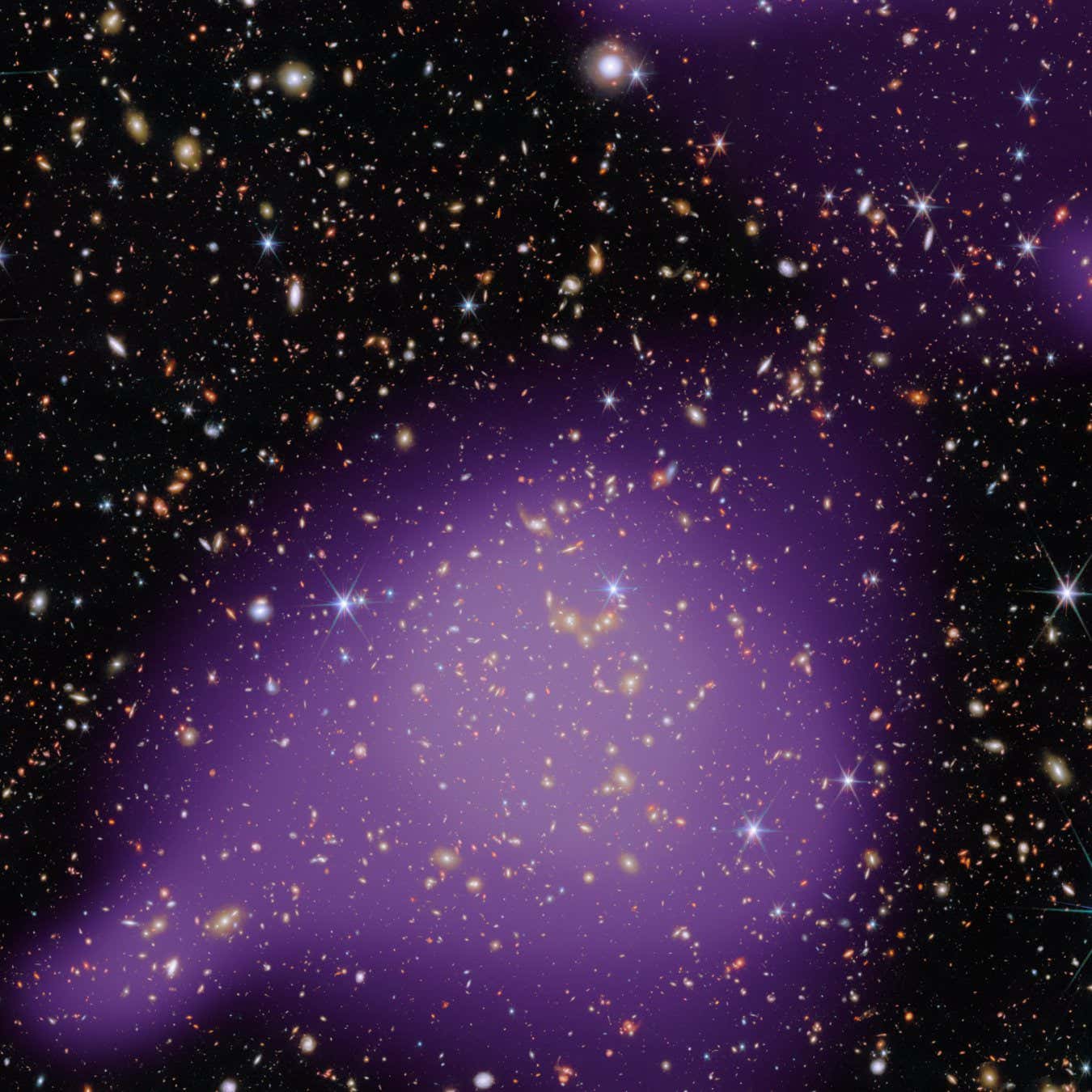 This new Picture of the Month from the NASA/ESA/CSA James Webb Space Telescope features an astounding number of galaxies. The objects in this frame span an incredible range of distances, from stars within our own Milky Way, marked by diffraction spikes, to galaxies billions of light-years away.?? The star of this image is a group of galaxies, the largest concentration of which can be found just below the centre of this image. These galaxies glow with white-gold light. We see this galaxy group as it appeared when the Universe was 6.5 billion years old, a little less than half the Universe???s current age. More than half of the galaxies in our Universe belong to galaxy groups like the one pictured here. Studying galaxy groups is critical for understanding how individual galaxies link up to form galaxy clusters, the largest gravitationally bound structures in the Universe. Belonging to a galaxy group can also alter the course of a galaxy???s evolution through mergers and gravitational interactions. The galaxy group pictured here is the most massive group in what???s called the COSMOS-Web field. COSMOS stands for Cosmic Evolution Survey. This survey has enlisted several telescopes, including Webb, the NASA/ESA Hubble Space Telescope, and ESA???s XMM-Newton space observatory to gaze deeply at a single patch of sky.?? COSMOS-Web aims to understand how massive structures like galaxy clusters came to be. Webb???s infrared capabilities and sensitive instruments have pushed the search for galaxy groups farther back into cosmic history, revealing galaxy groups as far back as when the Universe was only 1.9 billion years old ??? just 14% of its current age. This image combines infrared data from Webb???s Near-InfraRed Camera (NIRCam) instrument with further infrared observations from the Hubble Space Telescope. The X-ray data, shown in purple, highlights the presence of hot gas concentrated within the X-ray galaxy group. These X-ray data come from ESA???s XMM-Newton space observ