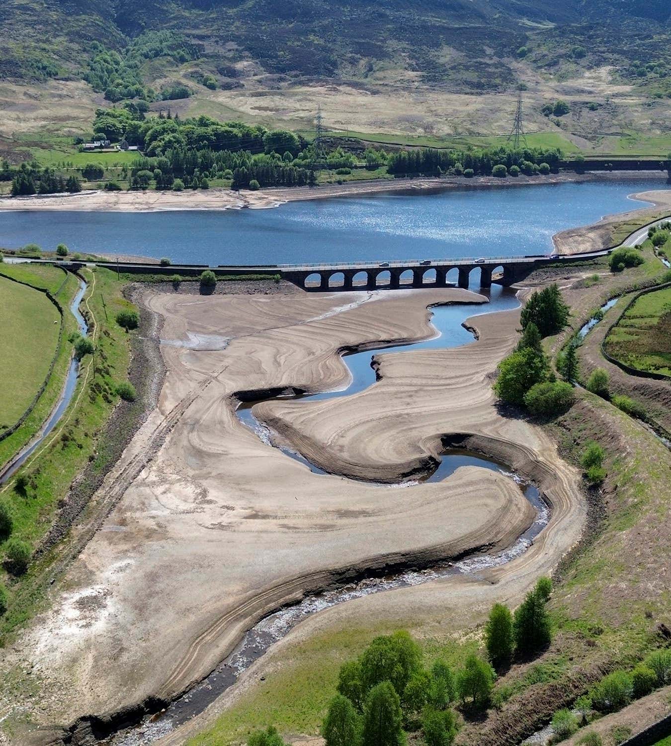WOODHEAD, DERBYSHIRE - MAY 11: An aerial view of Woodhead Reservoir amid low water levels on May 11, 2025 in Derby, England. United Utilities, a water utility in north-west England, warned customers to consume less water as they announced that regional reservoirs were at 69% capacity. Last year at this time, reservoirs were at 90%. The utility said there was a 